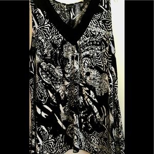 Sleeveless, very cute & soft top. Design is slimming. Almost brand new.